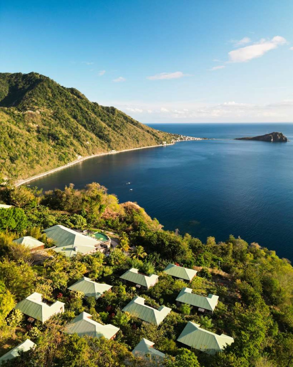 Jungle Bay from the air, its villas set into the cliffside above the bay